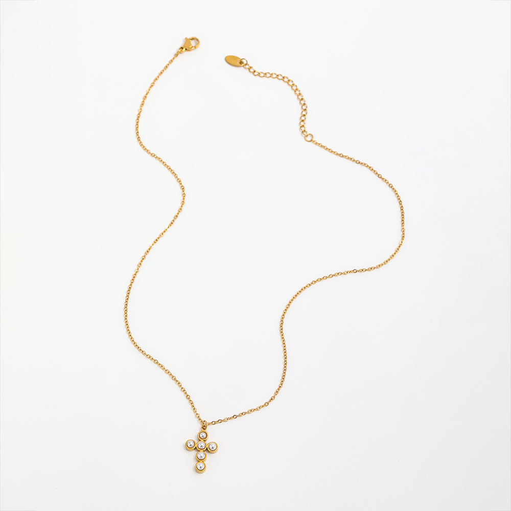 Gold necklace with a small pendant on a white background
