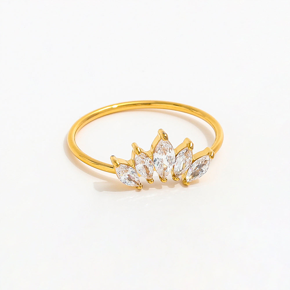 Gold ring with clear gemstones on a white background