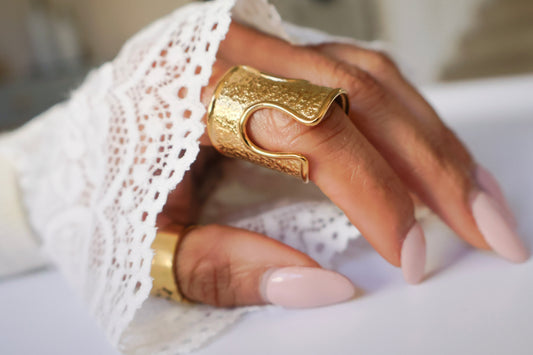 Gold ring on a finger with a blurred background