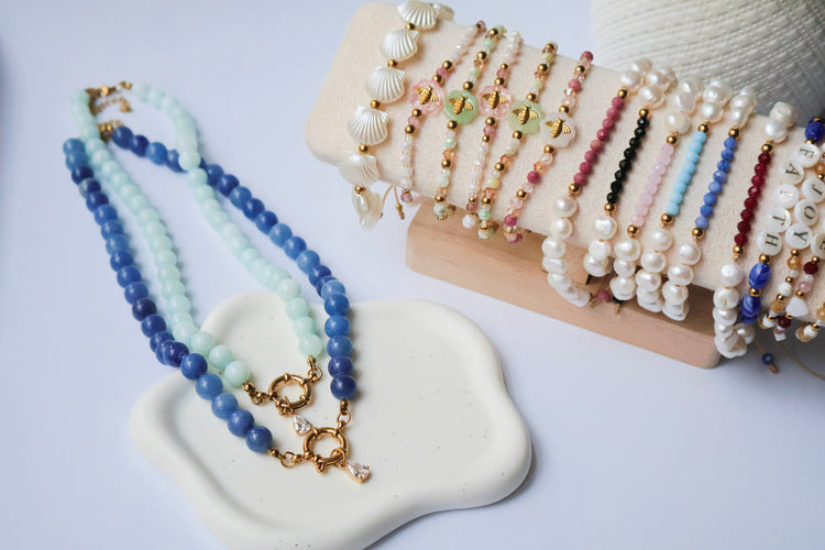 Handmade Beaded and colorful bracelets and necklaces on white background