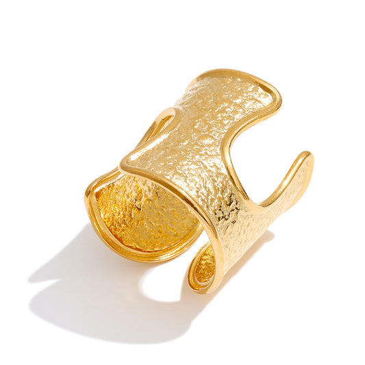 Gold textured ring on a white background