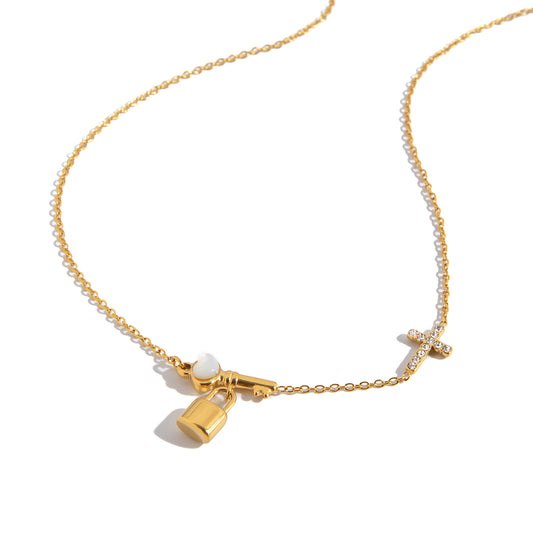 Gold necklace with lock charm on a white background