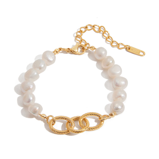 Pearl bracelet with gold chain on a white background
