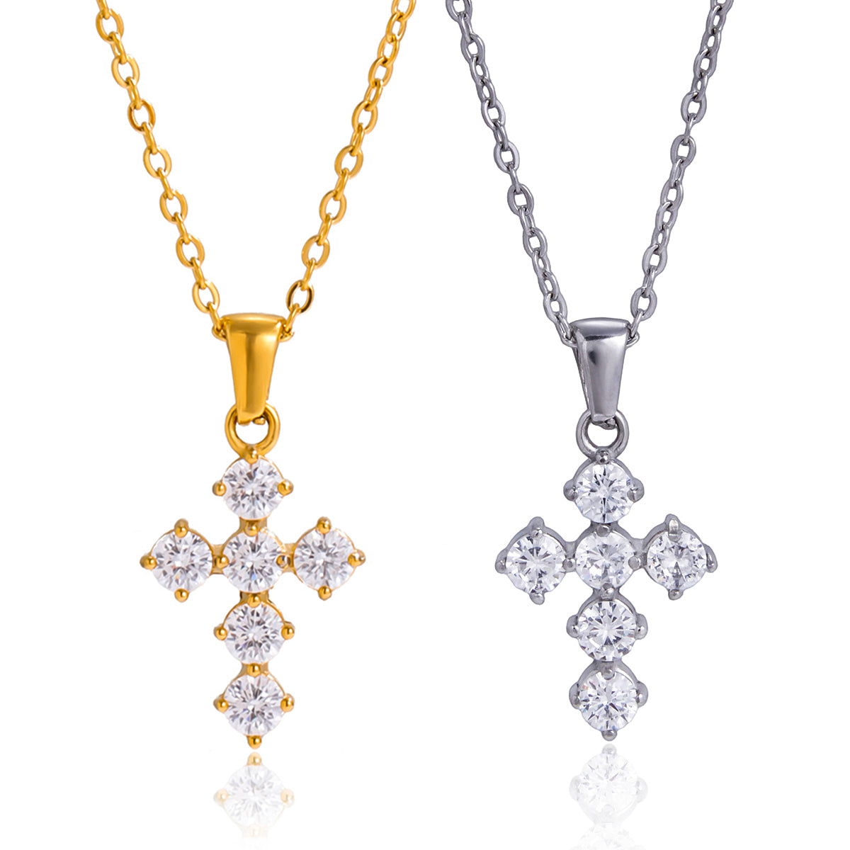 Gold and silver cross-shaped pendants on chains against a white background