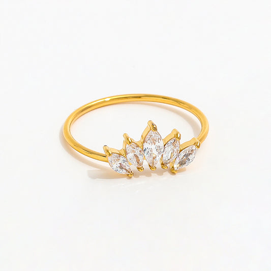 Gold ring with clear gemstones on a white background