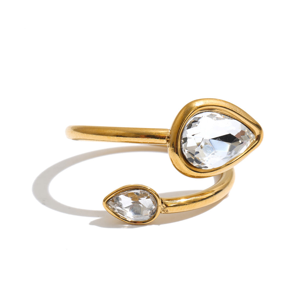 Radiance Double Crystal Ring in 18K gold plating featuring two clear teardrop-shaped crystals on an adjustable open band, photographed on a white background.