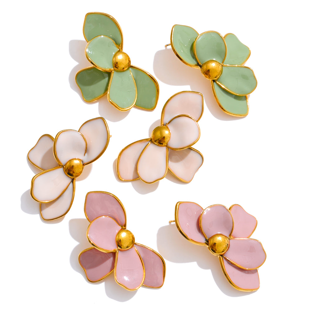 Set of floral earrings with gold centers on a white background