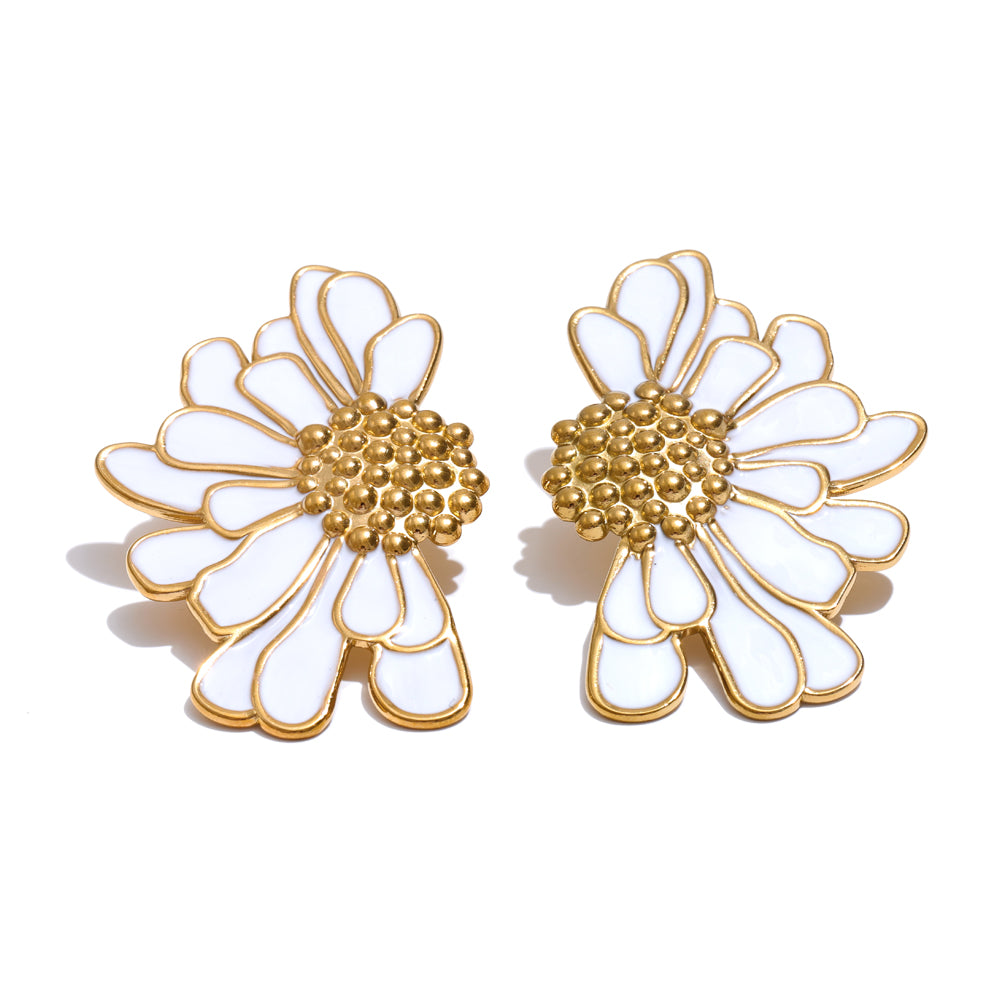 Pair of flower-shaped earrings with gold and white design on a white background