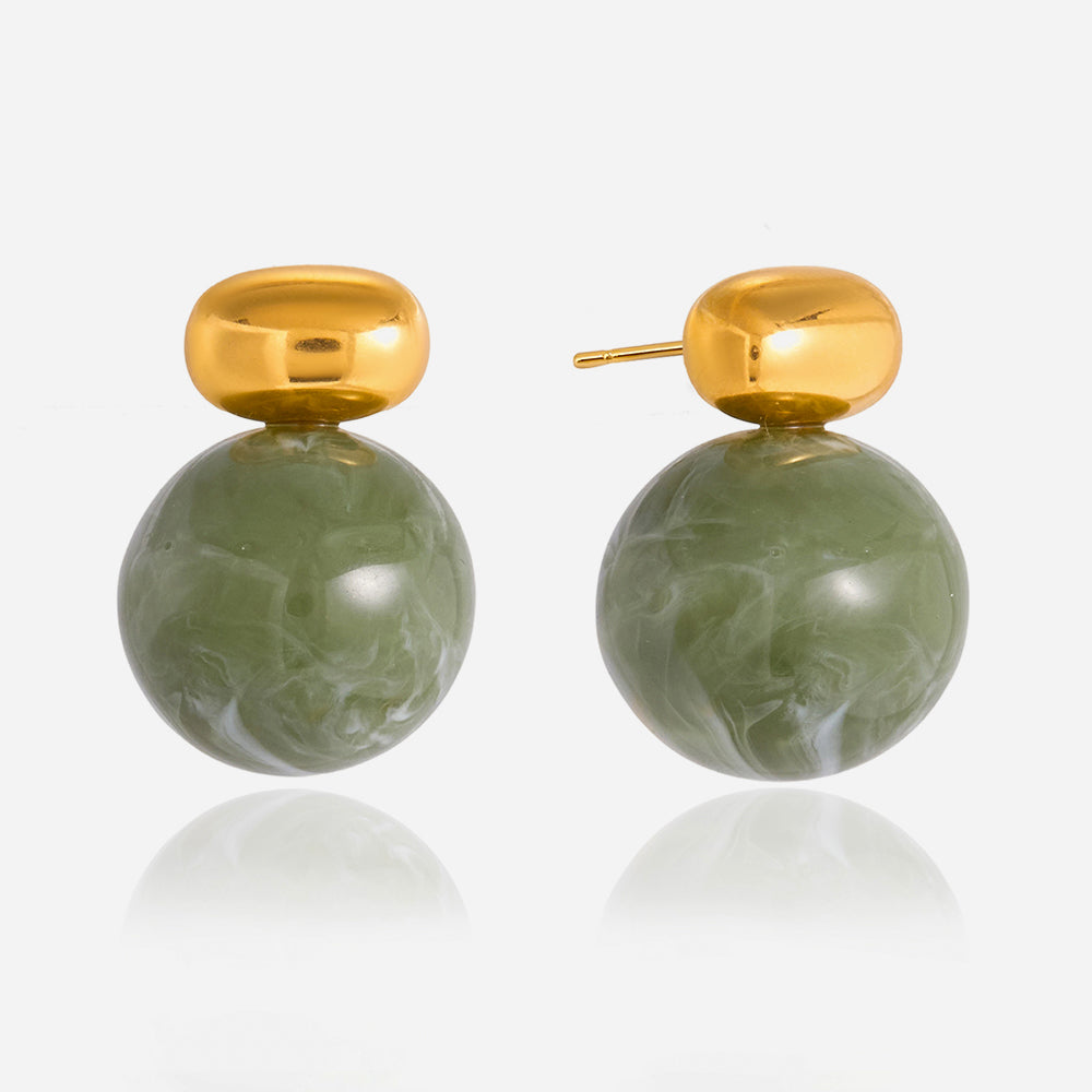 Gold and green marbleized earrings on a white background