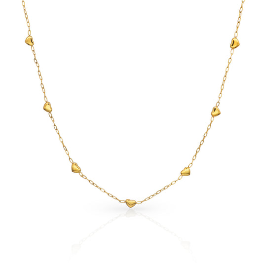 Gold necklace with heart-shaped pendants on a white background