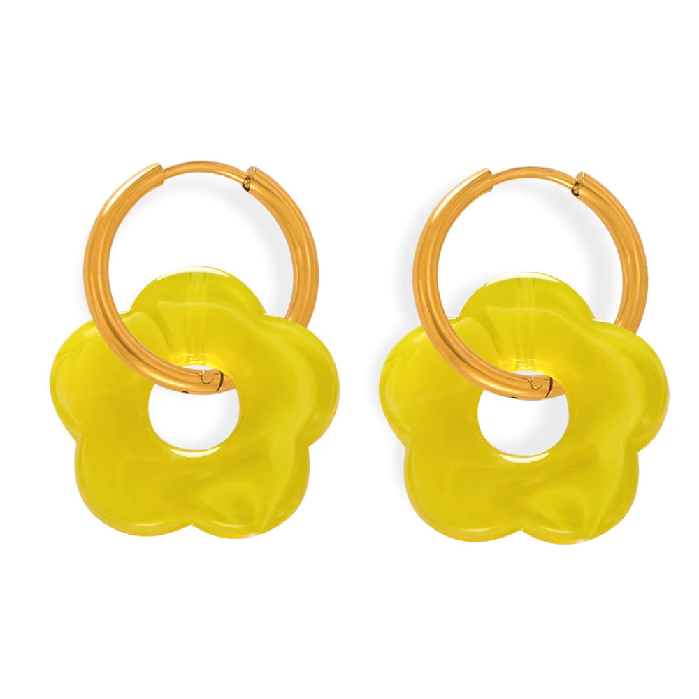 Pair of yellow flower-shaped earrings with wooden loops on a white background