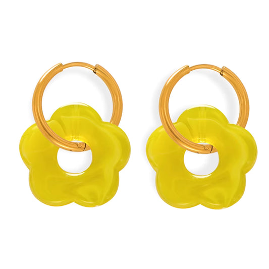 Pair of yellow flower-shaped earrings with wooden loops on a white background