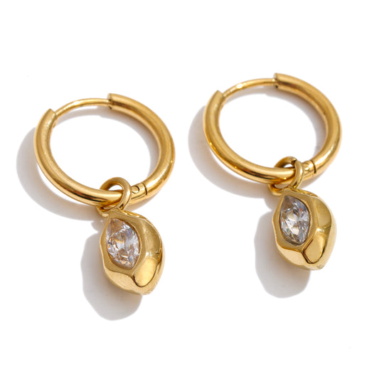 Pair of Promise Charm Huggie Earrings featuring polished 18K gold-plated hoops with dangling oval charms and clear zircon stones on a white background.