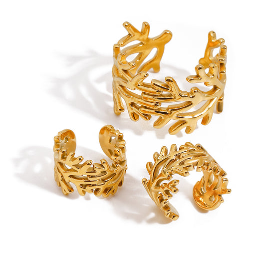 Set of gold openwork cuffs on a white background