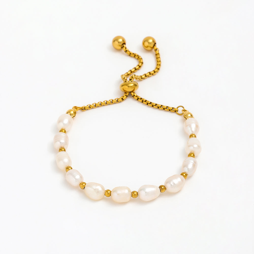 Pearl bracelet with gold accents on a white background