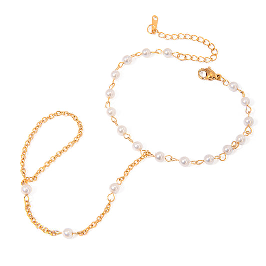 Gold chain necklace with pearl beads on a white background