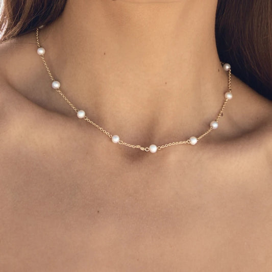 Pearl necklace on a person's neck