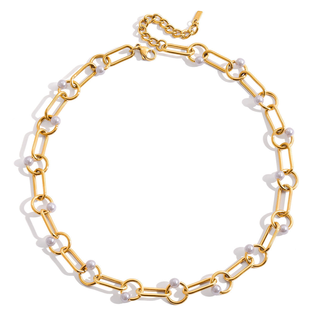 Gold chain necklace with white pearls on a white background