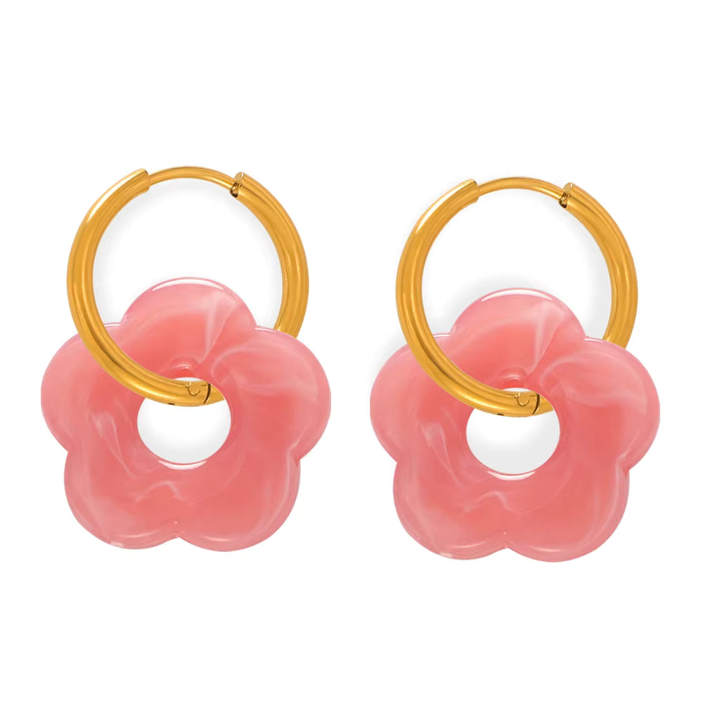 Pair of hoop earrings with pink floral designs and gold accents on a white background