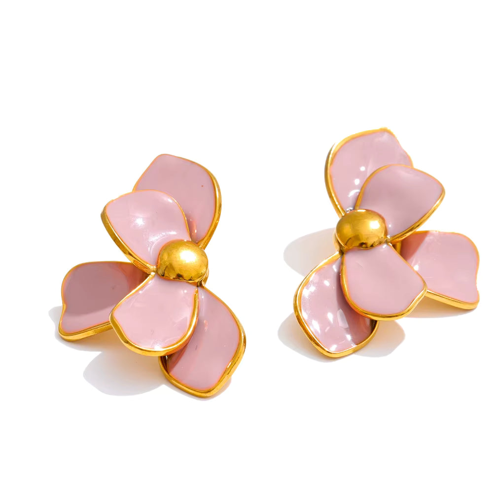 Pink flower-shaped earrings with gold accents on a white background