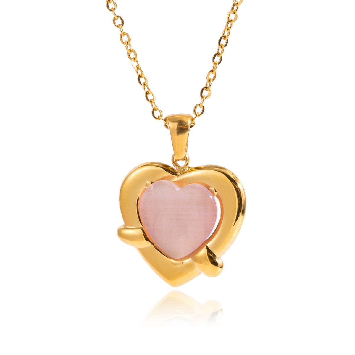 Gold heart-shaped necklace with a pink center on a white background