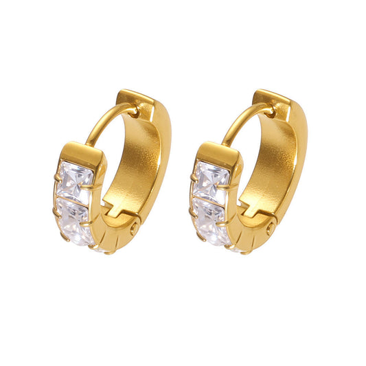 Gold hoop earrings with clear gemstones on a white background