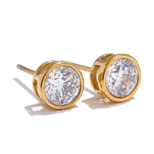 Gold stud earrings with clear gemstones on a white background