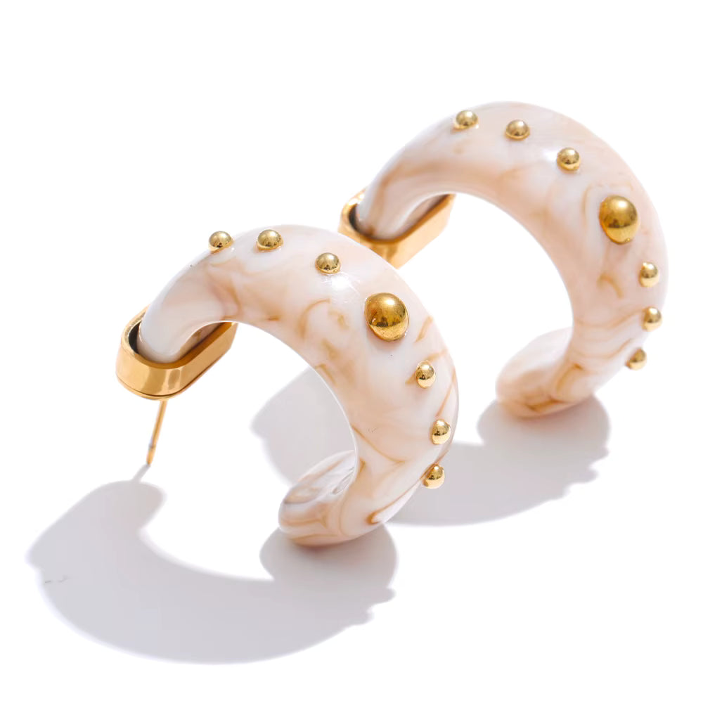 Pair of earrings with gold accents on a white background
