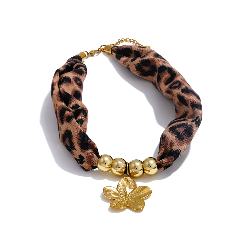 Leopard print necklace with gold beads and butterfly charm on a white background