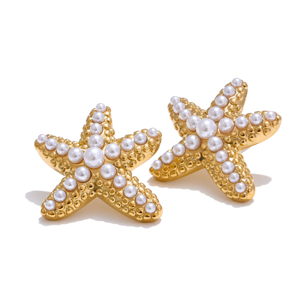 Gold starfish earrings with pearl embellishments on a white background