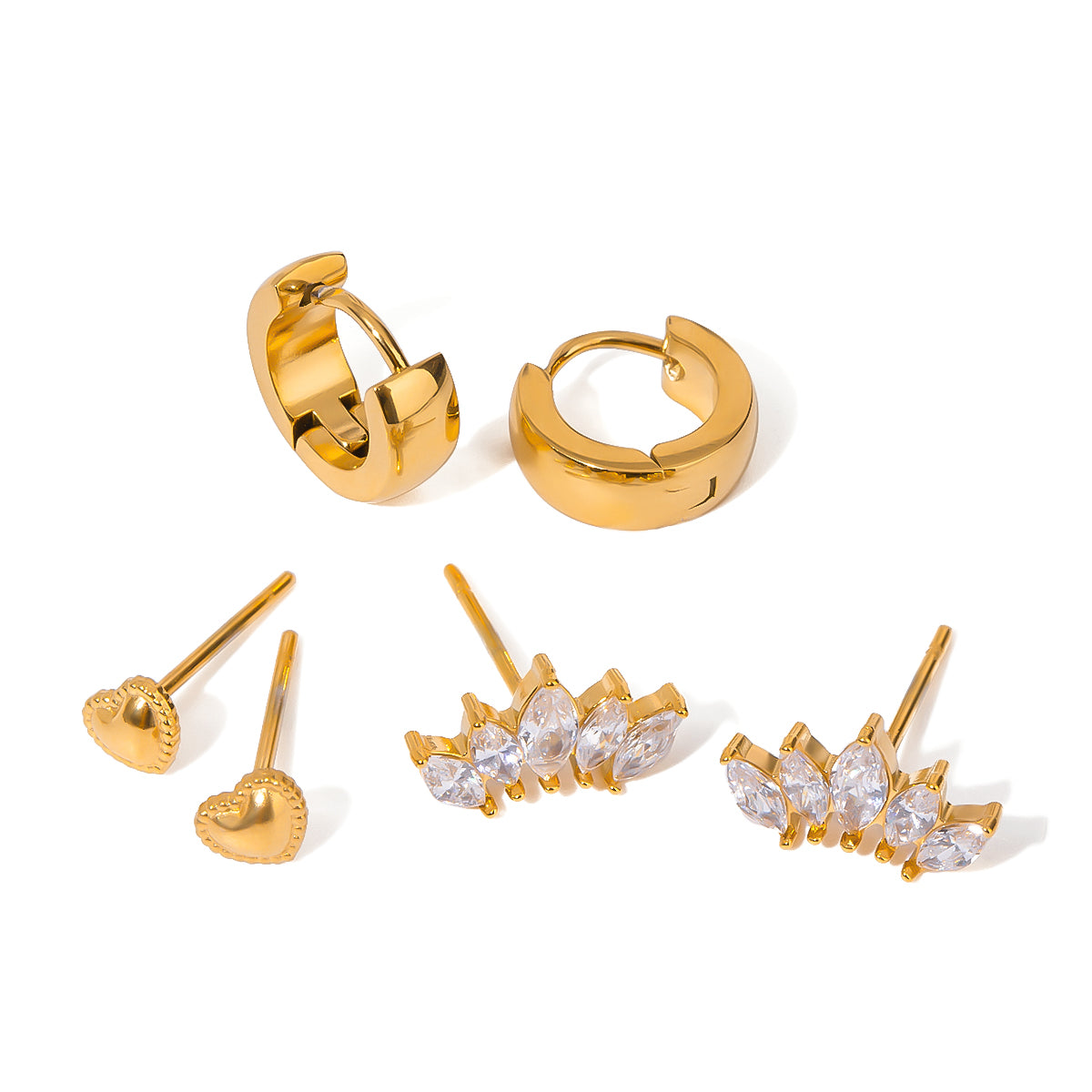 Set of gold earrings including hoop, heart, and diamond-studded designs on a white background