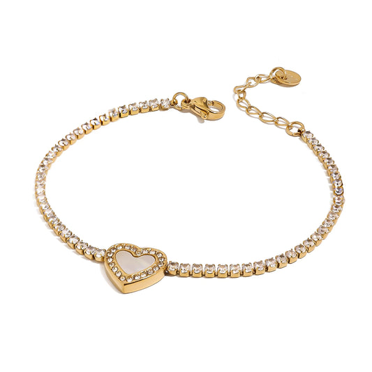 Gold bracelet with a heart-shaped charm on a white background