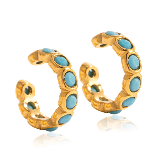 Ear cuff earrings with turquoise stones on a white background