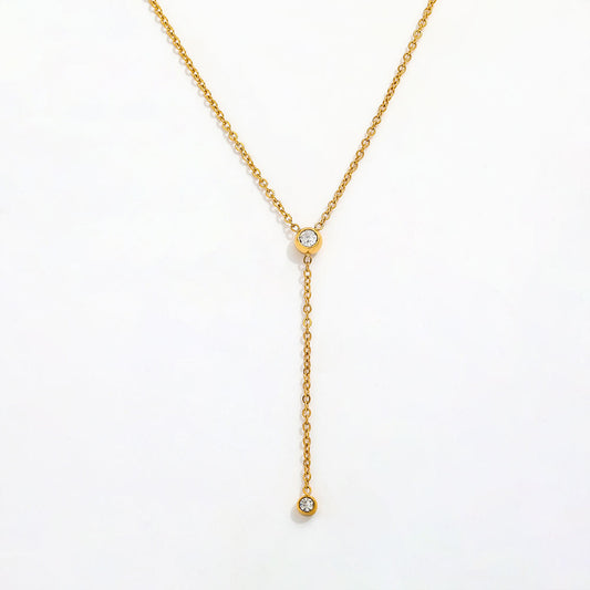 Gold necklace with small diamonds on a white background