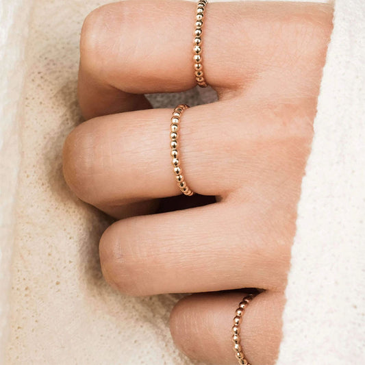 18k gold plated dainty beaded ring on fingers