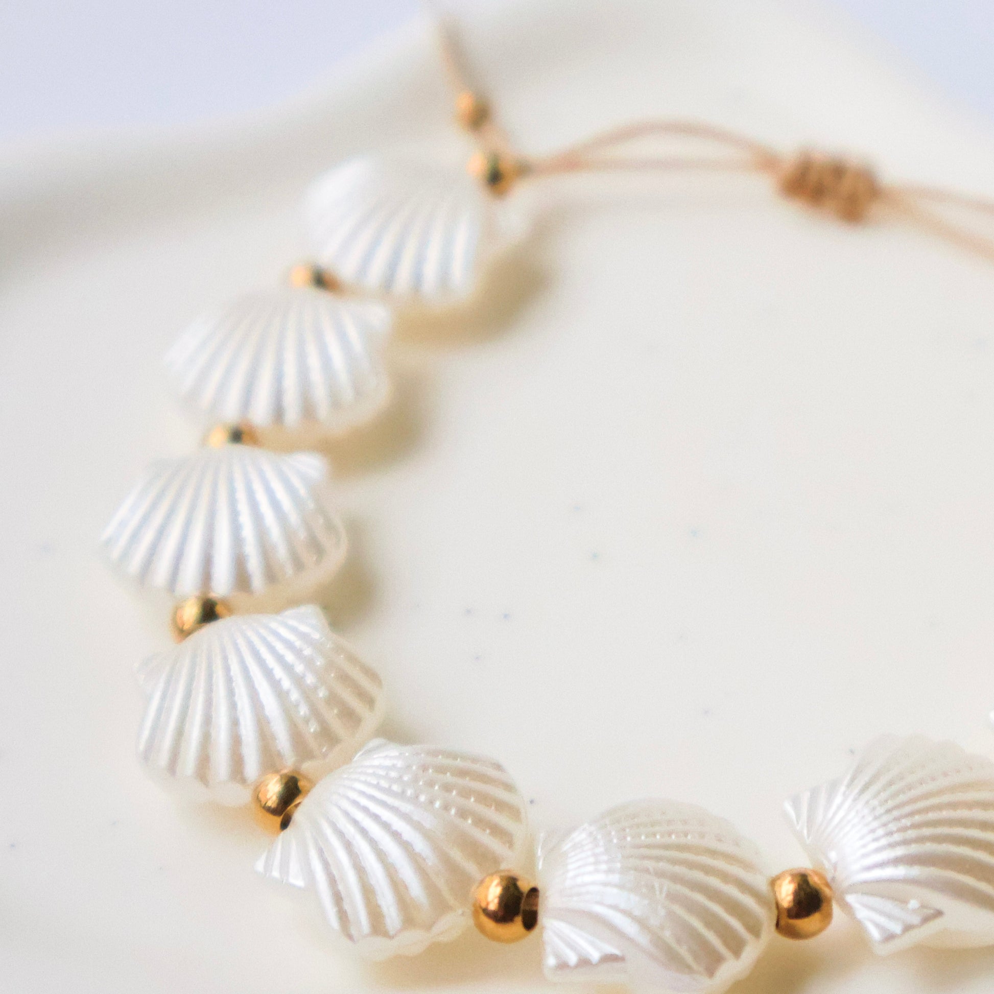 Necklace with shell-like beads on a light background